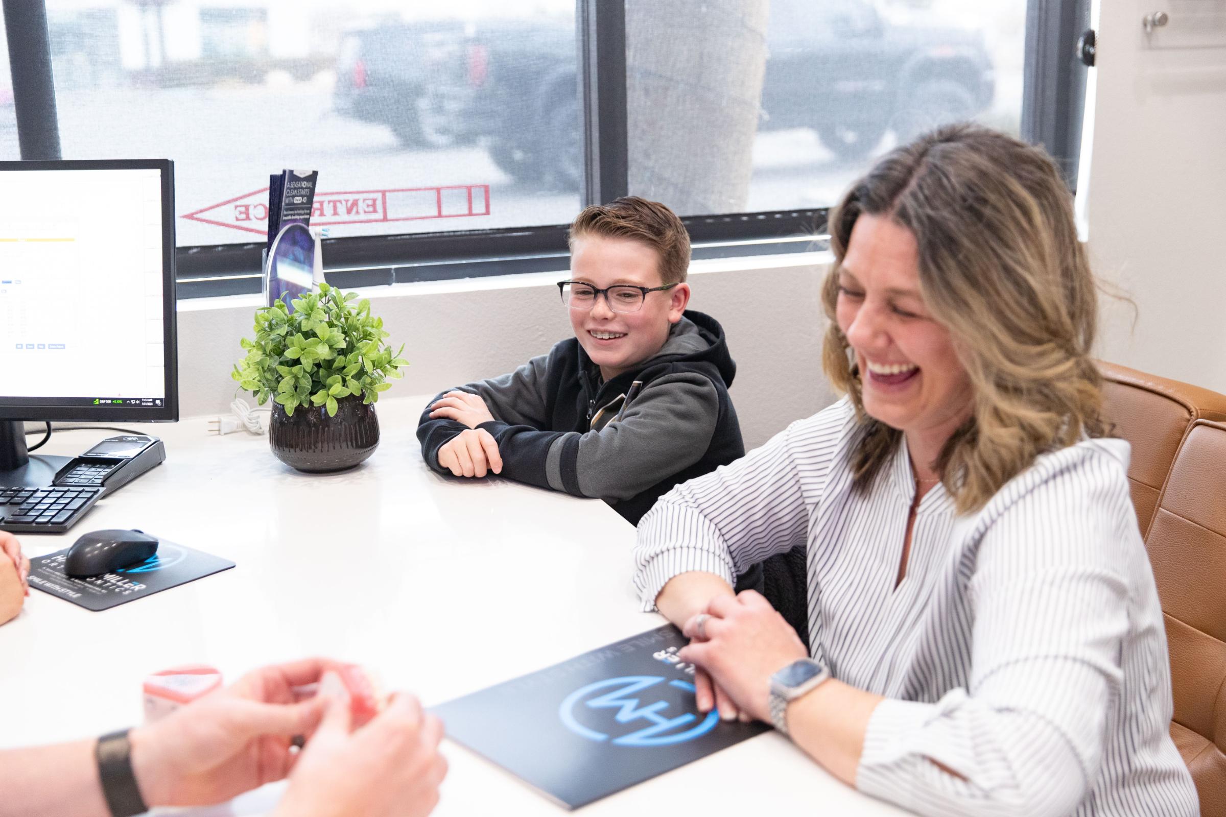 family smiling with braces